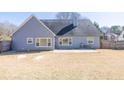 Exterior home featuring a gray siding, windows overlooking the backyard, and a concrete patio at 1270 Platinum Dr, Hoschton, GA 30548