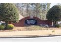 A brick community welcome sign reads 'Hamilton Springs', with lush greenery around a neighborhood entrance at 1270 Platinum Dr, Hoschton, GA 30548