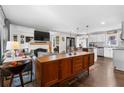 Open-concept living space with a fireplace, modern furniture, and hardwood floors that connects to the kitchen at 2746 Hedgewood Nw Dr, Atlanta, GA 30311