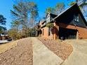 Side view of a two-story brick home with a two-car garage at 4665 Guilford Forest Sw Dr, Atlanta, GA 30331