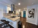 Updated kitchen featuring granite countertops, stainless steel appliances, a breakfast bar, and dark hardwood floors at 280 Spellman Nw St, Atlanta, GA 30314