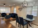 Open living and dining area with hardwood floors, a glass table, and modern lighting at 280 Spellman Nw St, Atlanta, GA 30314