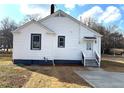 Rear view of the house featuring a white exterior, gray accents, and a concrete back patio at 5091 Newark Ave, Clarkdale, GA 30111