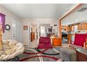 Comfortable living area open to kitchen with neutral carpet, light walls and bright light at 842 Third St, Stone Mountain, GA 30083