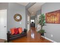 Inviting hallway with hardwood floors, gray walls, decorative accents, and access to living spaces at 1009 S Creek Dr, Villa Rica, GA 30180