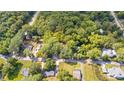A tranquil bird's eye view of a lush property nestled among trees and neighboring houses at 159 Forest Ave, Social Circle, GA 30025