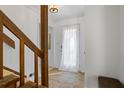 Bright entryway with tile floor, wooden staircase, and white front door with window at 3798 Valley Brook Rd, Snellville, GA 30039