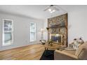 Bright living room with stone fireplace, hardwood floors, and neutral decor at 3798 Valley Brook Rd, Snellville, GA 30039