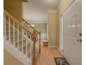 Bright foyer with hardwood floors and staircase leading to the second floor at 815 Lake Stone Lea Dr, Oxford, GA 30054