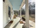 Relaxing front porch with rocking chairs, complemented by stylish welcome mats at 815 Lake Stone Lea Dr, Oxford, GA 30054