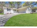 Charming single-story home with a well-manicured lawn and painted white brick exterior at 819 Forrest Se Cir, Atlanta, GA 30354