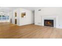 Open-concept living area with hardwood floors and cozy fireplace at 1205 Gettysburg Pl, Sandy Springs, GA 30350