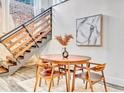 Cozy dining area with a round wood table and a modern wooden staircase nearby at 650 Glen Iris Ne Dr # 15, Atlanta, GA 30308