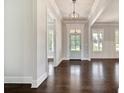 Bright foyer featuring dark hardwood floors, white trim, and a modern pendant light at 112 Dallas Mark Drive, Canton, GA 30115