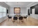 Elegant dining room with a modern table set, stylish lighting, and wall decor at 142 Parkway Dr, Fairburn, GA 30213