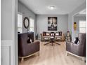 Comfortable living room featuring hardwood floors, a decorative fireplace, and large windows at 142 Parkway Dr, Fairburn, GA 30213