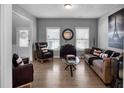 Bright living room with hardwood floors, stylish furniture, and plenty of natural light at 142 Parkway Dr, Fairburn, GA 30213