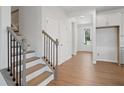 Bright entryway featuring hardwood floors, staircase, and white trim details at 385 Riverwood Pass, Dallas, GA 30157