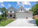 Stunning two-story home with a three-car garage and a well-manicured front yard at 385 Riverwood Pass, Dallas, GA 30157