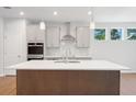 Bright kitchen featuring a large island and stainless steel appliances under recessed lighting at 385 Riverwood Pass, Dallas, GA 30157