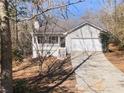 Charming single Gathering home with a covered front porch, two-car garage, and landscaped yard at 405 Willow Shoals Dr, Covington, GA 30016