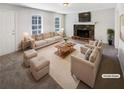 Bright living room with a stone fireplace, plush seating, and large windows at 405 Willow Shoals Dr, Covington, GA 30016