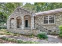 Stone house featuring an arched entryway leading to the front door at 1110 Asbury St, Oxford, GA 30054