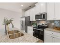 Well-equipped kitchen with stainless steel appliances, granite countertops, and white cabinetry offers both style and functionality at 228 Epping Street # 8, Stockbridge, GA 30281