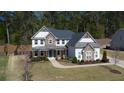 Charming home with stone accents, covered porch, and beautifully landscaped front yard and lawn at 6650 Canyon Cv, Cumming, GA 30028