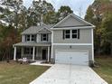 Charming two-story home with gray siding, black shutters, and a two-car garage at 1102 Campbell Rd, Covington, GA 30014