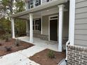Inviting front porch with white columns and brick accents at 1102 Campbell Rd, Covington, GA 30014