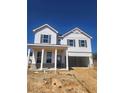 Charming two-story home featuring white siding and an attached two-car garage on a construction site at 2634 Mourning Dove Drive (Lot 41), Grayson, GA 30017
