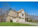 Inviting home featuring a well-kept lawn, a three-car garage, and beautiful siding at 3610 Ansley Manor Ct, Cumming, GA 30028