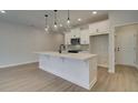 Bright kitchen featuring white cabinets, an island, and stainless steel appliances at 4529 Twinberry Dr, Powder Springs, GA 30127