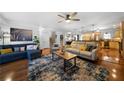 Open living room featuring hardwood floors, comfortable sofas, and an open kitchen layout at 4970 Lost Mountain Nw Trce, Kennesaw, GA 30152