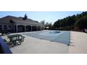 Community pool covered with a mesh winter safety cover, ready for colder months at 536 Highland Falls Dr, Hiram, GA 30141