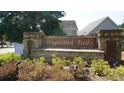Stone entrance sign with 'Highland Falls' inscription surrounded by plants at 536 Highland Falls Dr, Hiram, GA 30141