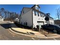 View of new construction townhome exterior featuring white brick, garage and paved driveway at 400 Renwood Trl, Johns Creek, GA 30097