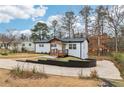 Beautifully renovated white brick home with a modern front porch and spacious driveway at 5901 Miller Rd, Austell, GA 30106