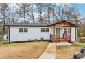 Charming single-story home with front porch, white brick exterior, and dark trim at 5901 Miller Rd, Austell, GA 30106