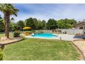Inviting backyard pool with waterfall feature, lounge chairs, and lush landscaping at 820 Nob Ridge Dr, Marietta, GA 30064