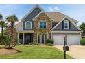 Charming two-story home with a manicured lawn, stone accents, and a welcoming two-car garage at 820 Nob Ridge Dr, Marietta, GA 30064