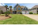 Charming two-story home with stone and siding, manicured lawn, and a two-car garage at 820 Nob Ridge Dr, Marietta, GA 30064