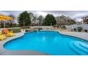 Sparkling backyard pool featuring a waterfall feature, lush greenery, and cozy seating area at 820 Nob Ridge Dr, Marietta, GA 30064