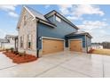 The side of the home features two garage doors with a modern concrete driveway at 700 Hedwig Drive (Lot 91), Mcdonough, GA 30252