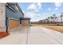 Side of home with two garage doors and concrete driveway at 700 Hedwig Drive (Lot 91), Mcdonough, GA 30252