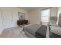 Bright bedroom with neutral tones, modern dresser, and plenty of natural light at 146 Silverton Dr, Dacula, GA 30019
