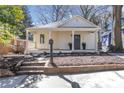Inviting single-story home featuring a cozy front porch and manicured yard at 1576 Elixir Sw Ave, Atlanta, GA 30314