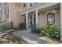 Tan building entrance featuring black doors, white columns and well maintained landscaping at 2400 Cumberland Se Pkwy # 212, Atlanta, GA 30339