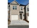 Charming townhome featuring a brick facade, garage, and inviting front entrance at 7016 Fringe Flower Dr # 88, Austell, GA 30168